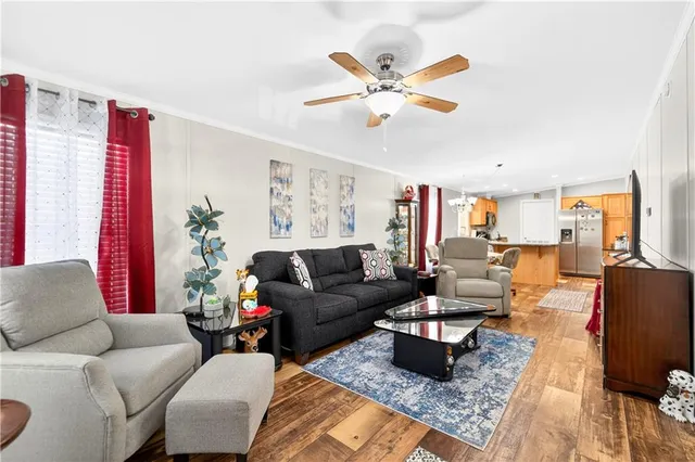 a living room with furniture wooden floor and a window