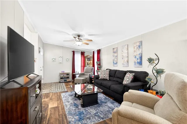 a living room with furniture and a flat screen tv