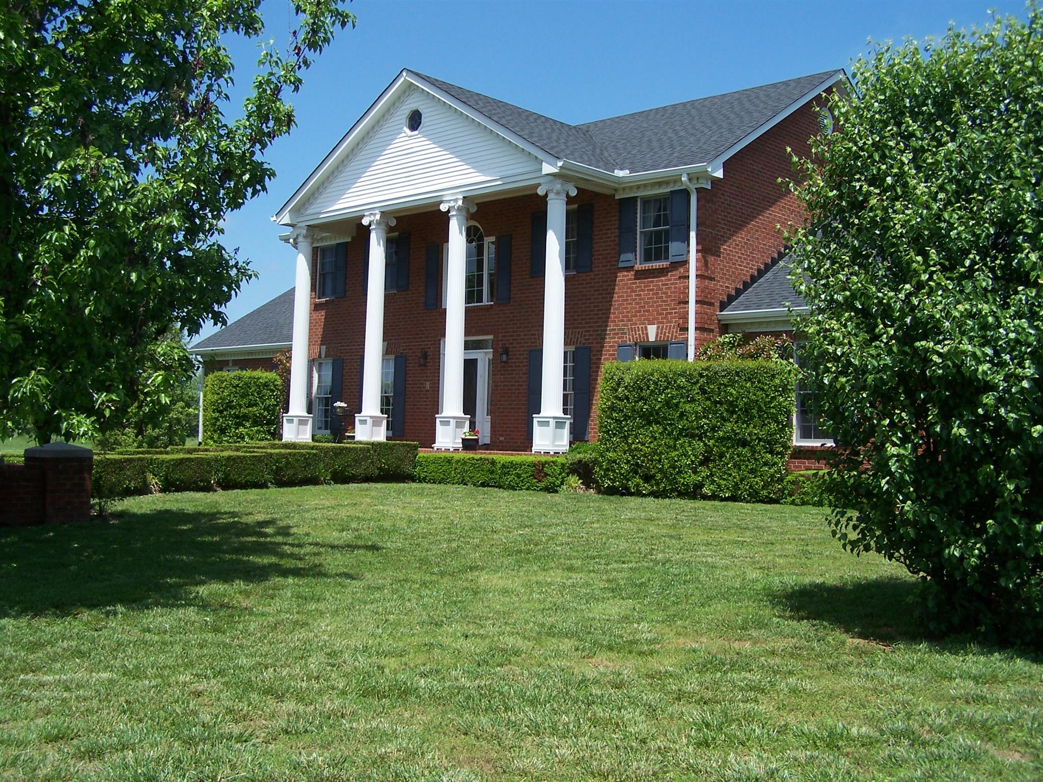 a front view of house with yard and green space