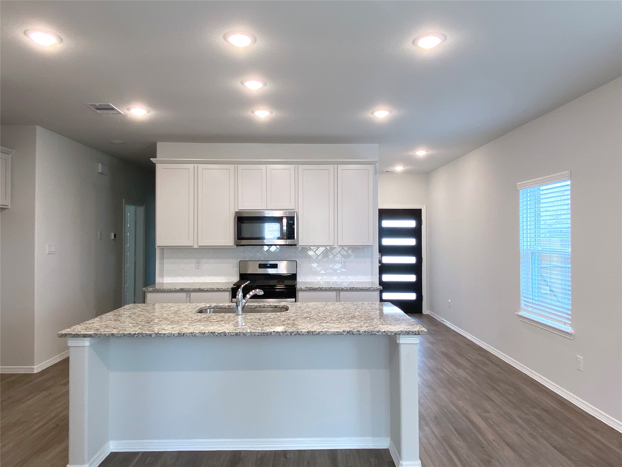 23338 Spring Genesis Lane Katy, TX 77493 - Photo 10 of 18 White cabinets in stainless steel appliances in the kitchen