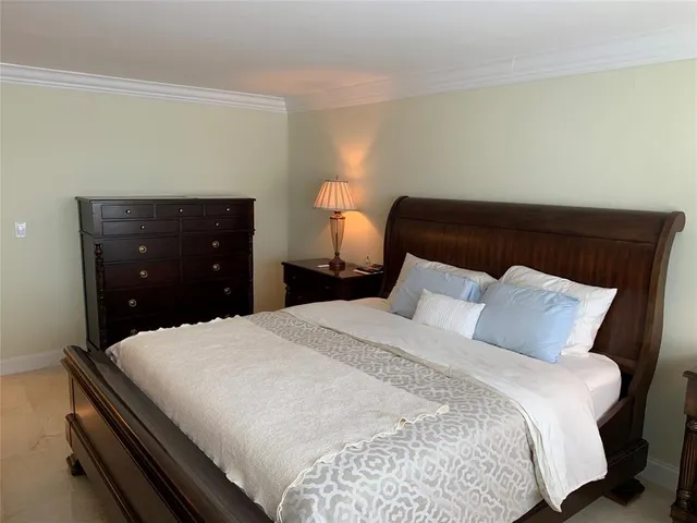 a bedroom with a bed and a lamp