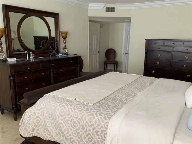 a bedroom with a bed and a dresser
