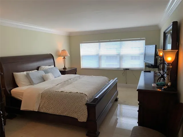 a bed room with a bed and a television