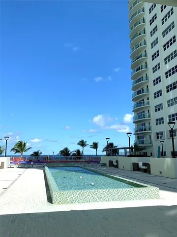 a view of yard with swimming pool and outdoor seating