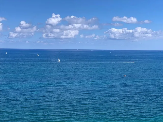 a balcony with table and chairs