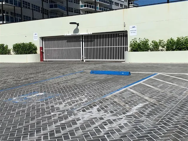 a view of a house with a yard and potted plants