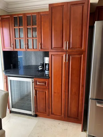 a kitchen with stainless steel appliances granite countertop a refrigerator and cabinets