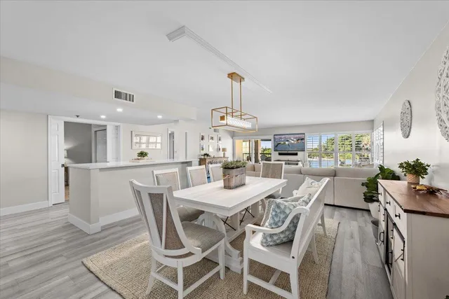 a dining room with furniture and wooden floor