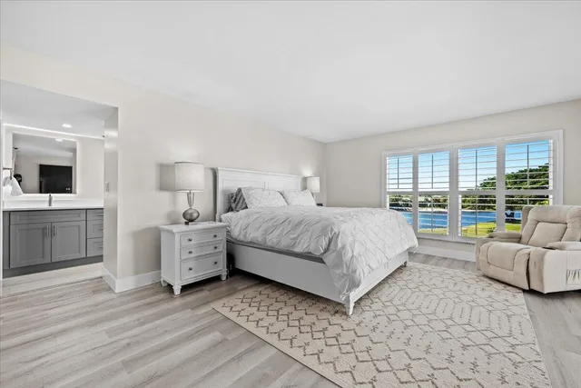 a bed room with a bed window and mirror