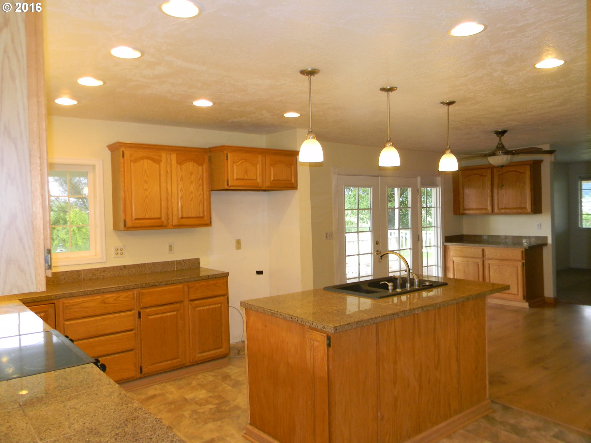 83442 Rodgers Road Creswell, OR 97426 - Photo 5 of 27 a kitchen with stainless steel appliances granite countertop a sink a counter space and a window