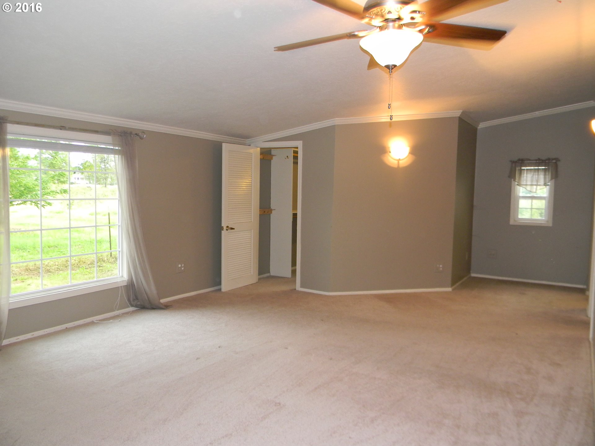 83442 Rodgers Road Creswell, OR 97426 - Photo 9 of 27 an empty room with windows and chandelier fan