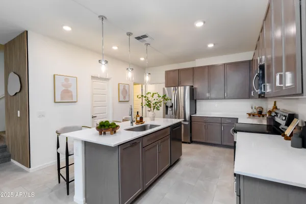 a kitchen with a sink stove and cabinets