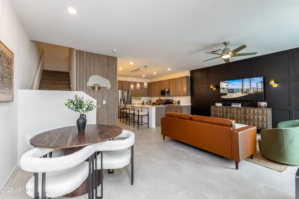 a living room with furniture and a dining table with kitchen view