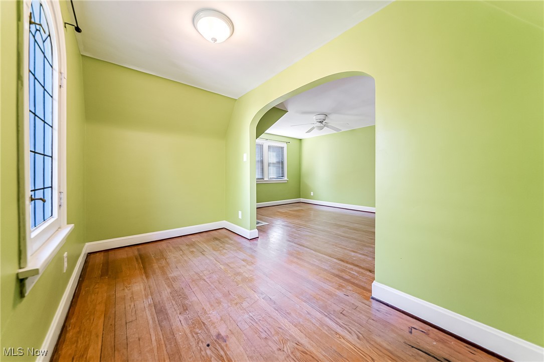 6711 Forest Avenue Parma, OH 44129 - Photo 17 of 33 Additional living space with light wood-style floors, arched walkways, baseboard heating, and a ceiling fan