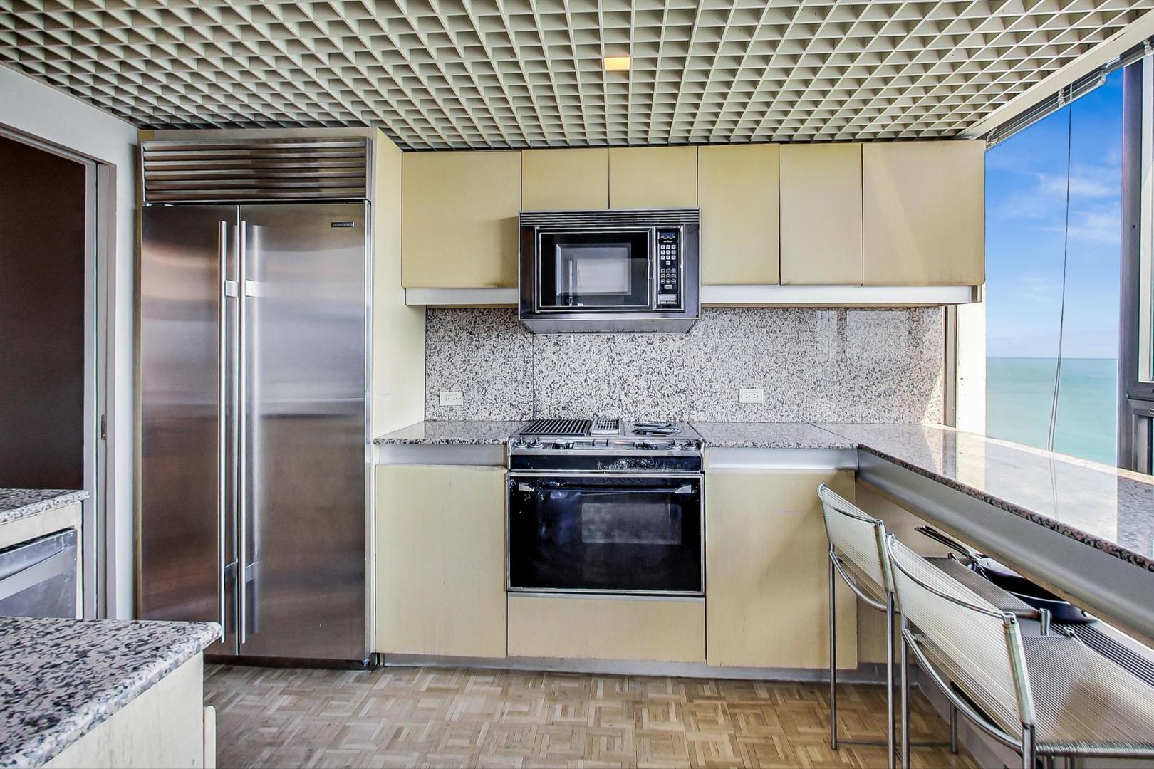 2800 North Lake Shore Drive, Unit 4216 Chicago, IL 60657 - Photo 12 of 29 a kitchen with a stove and a refrigerator