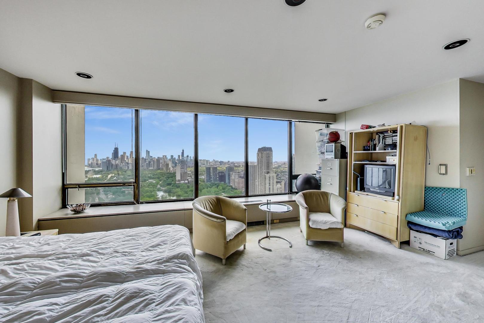 2800 North Lake Shore Drive, Unit 4216 Chicago, IL 60657 - Photo 19 of 29 a bedroom with furniture and a large window