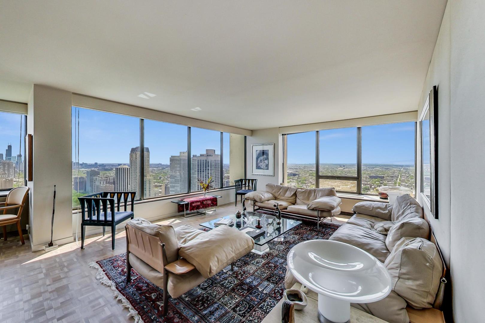 2800 North Lake Shore Drive, Unit 4216 Chicago, IL 60657 - Photo 5 of 29 a living room with furniture and a floor to ceiling window