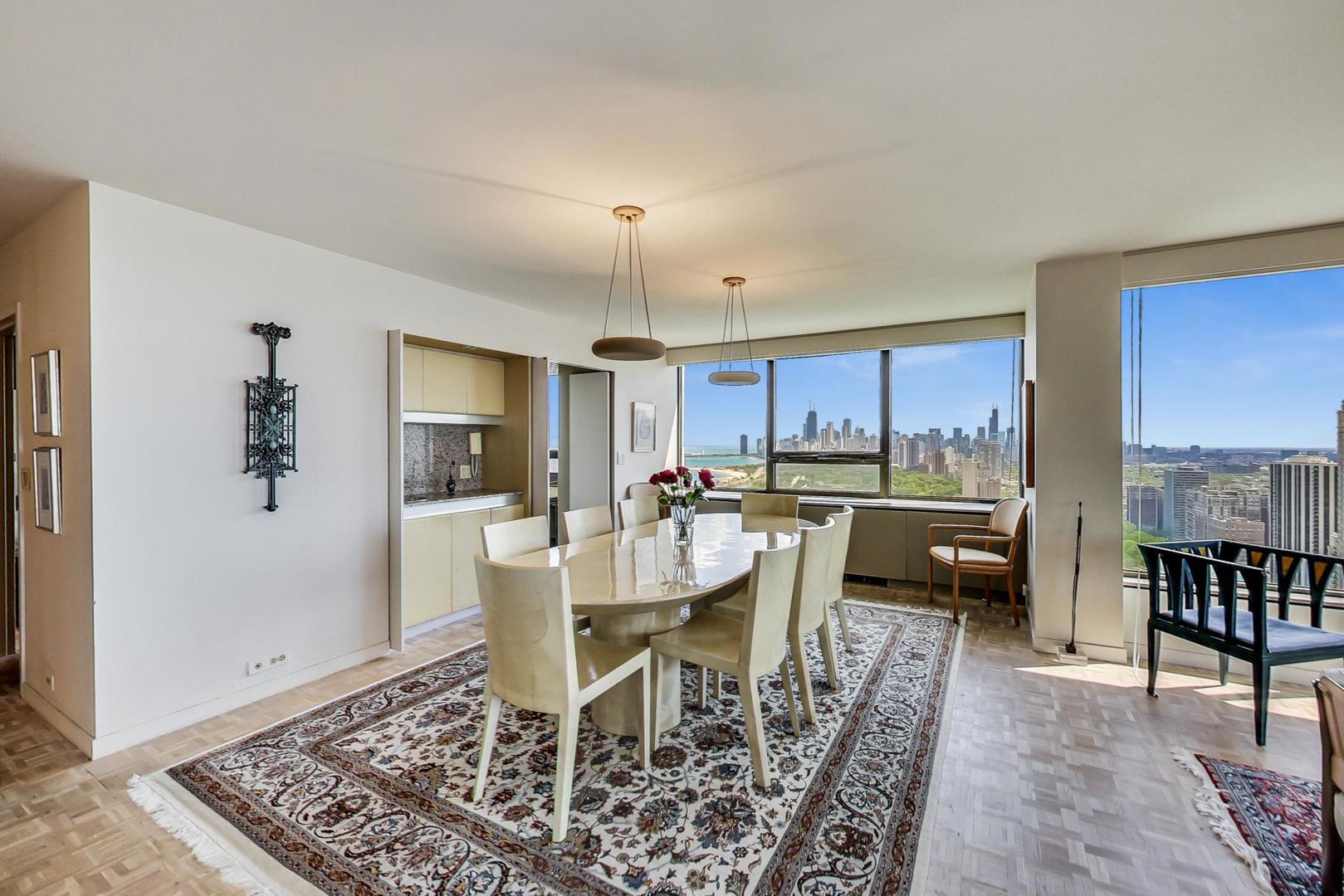 2800 North Lake Shore Drive, Unit 4216 Chicago, IL 60657 - Photo 7 of 29 a view of a dining room with furniture window and wooden floor