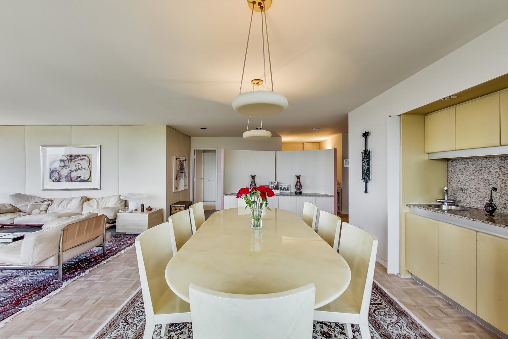 2800 North Lake Shore Drive, Unit 4216 Chicago, IL 60657 - Photo 8 of 29 a view of a dining room with furniture window and wooden floor