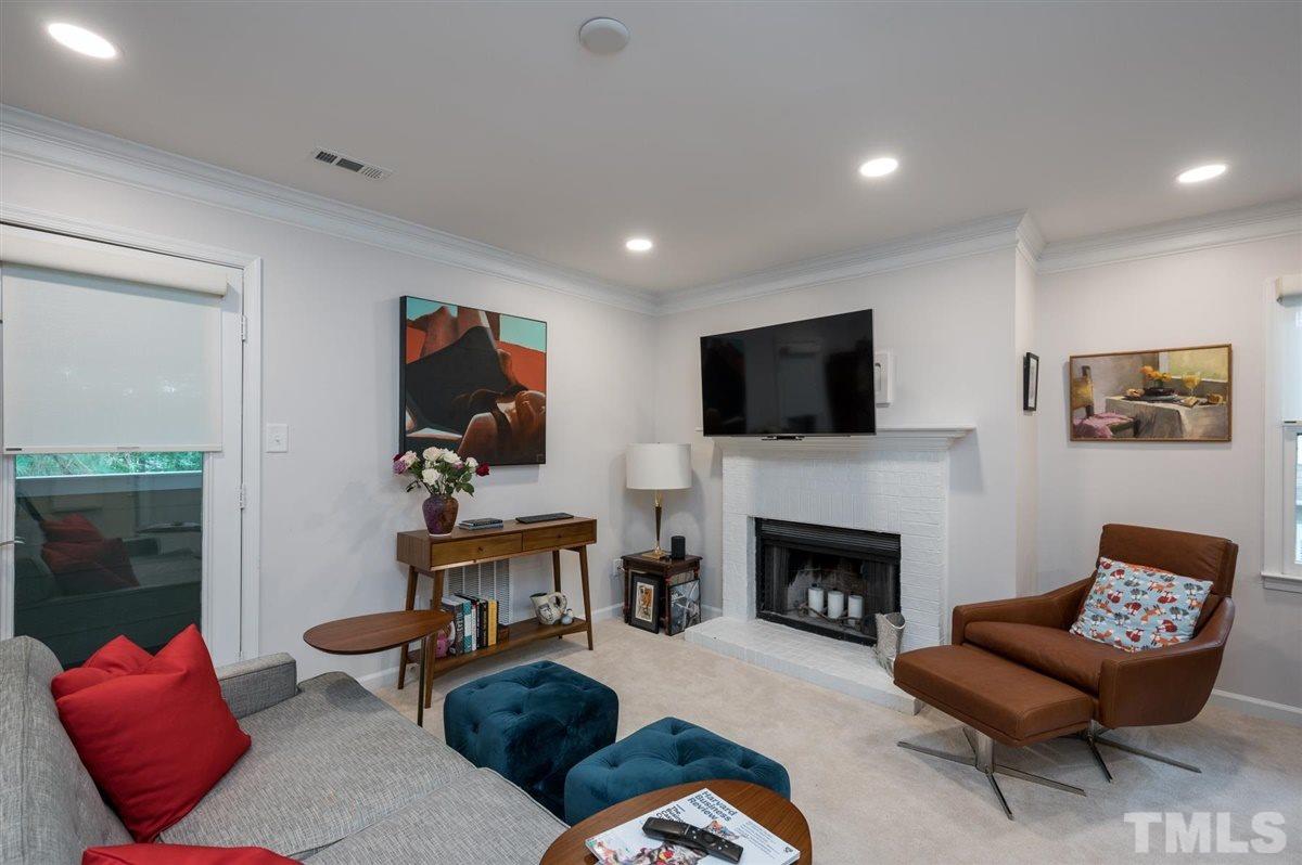 3245 Mill Run, Unit 3245 Raleigh, NC 27612 - Photo 1 of 24 a living room with furniture fireplace and flat screen tv