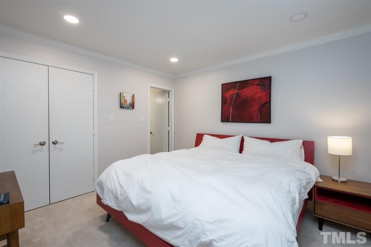 3245 Mill Run, Unit 3245 Raleigh, NC 27612 - Photo 14 of 24 a bedroom with a bed and a lamp