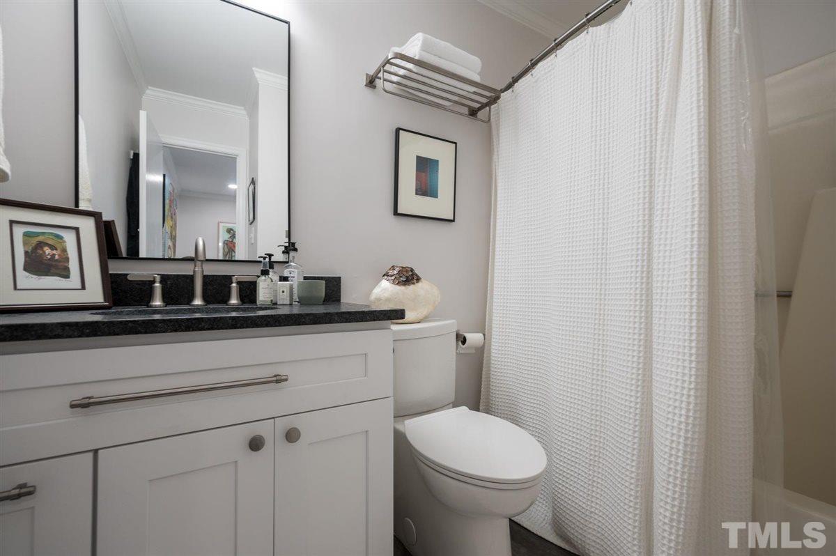 3245 Mill Run, Unit 3245 Raleigh, NC 27612 - Photo 20 of 24 a bathroom with a sink a toilet and mirror