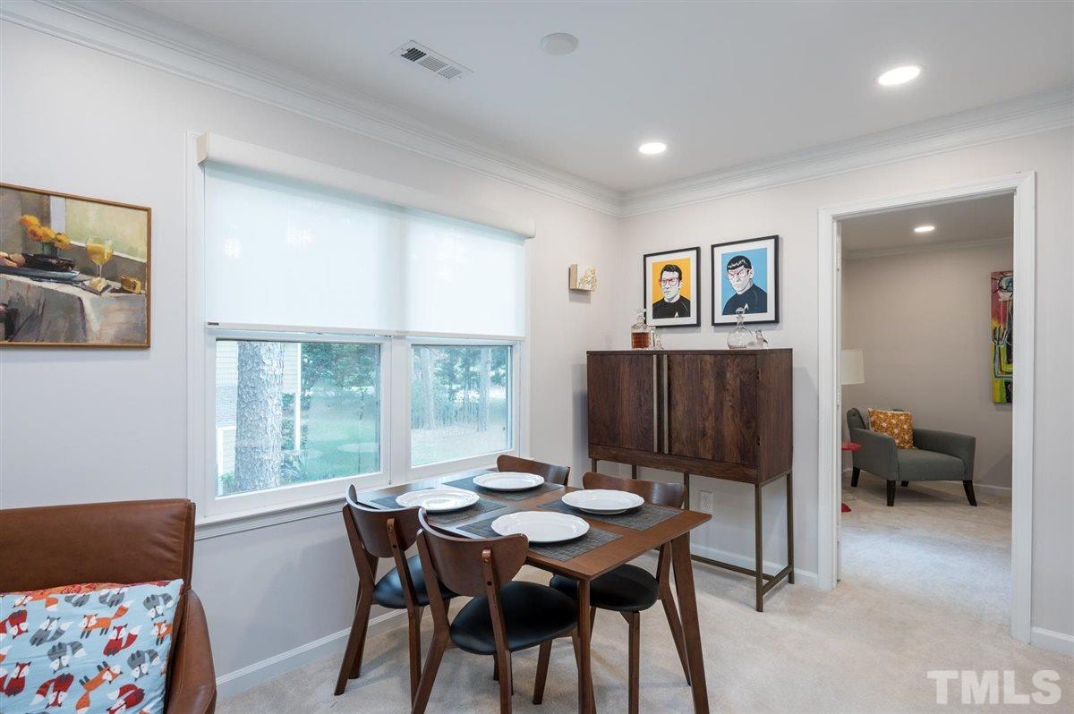 3245 Mill Run, Unit 3245 Raleigh, NC 27612 - Photo 8 of 24 a view of a dining room with furniture and a window