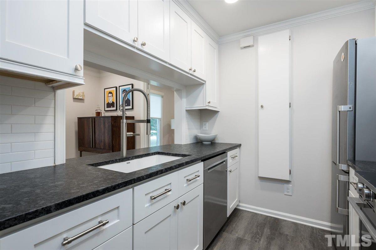 3245 Mill Run, Unit 3245 Raleigh, NC 27612 - Photo 10 of 24 a kitchen with stainless steel appliances granite countertop a sink and a refrigerator