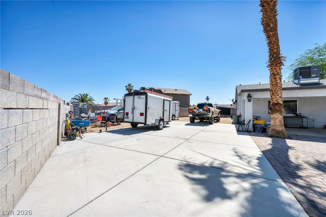 5882 Rio Tinto Way Las Vegas, NV 89110 - Photo 44 of 56 A spacious driveway and private yard await, offering ample room for vehicles and outdoor pursuits.