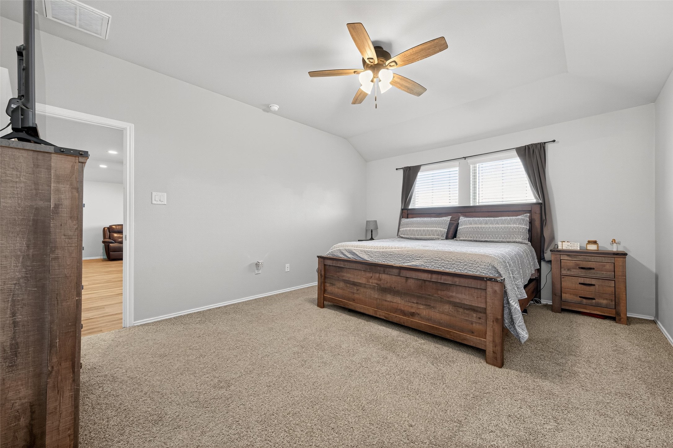 23706 Blodgett Peak Trail Spring, TX 77373 - Photo 13 of 31 This spacious primary bedroom features a cozy carpet, a large window with curtains for natural light, and a ceiling fan.