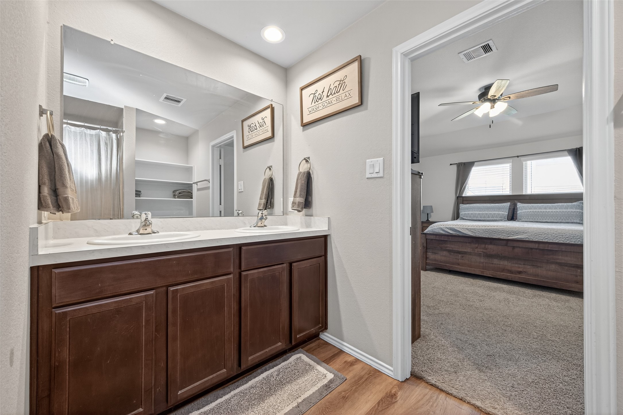 23706 Blodgett Peak Trail Spring, TX 77373 - Photo 15 of 31 a en suite bathroom with a double vanity sink and a mirror