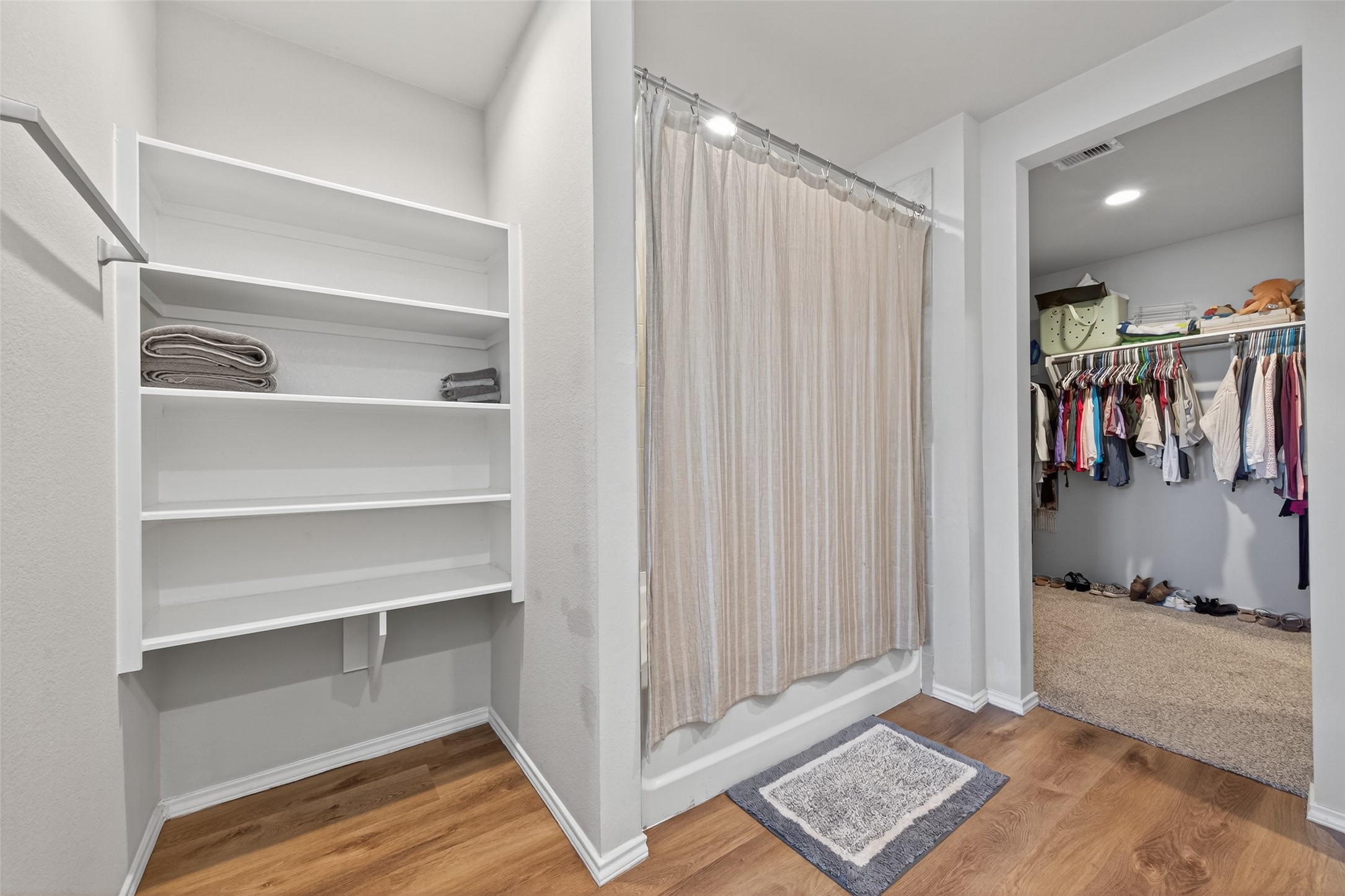 23706 Blodgett Peak Trail Spring, TX 77373 - Photo 16 of 31 A well-organized primary bathroom, shower/tub combo, with vinyl plank floors, and a LARGE Walk in closet featuring built-in shelves and plenty of storage.