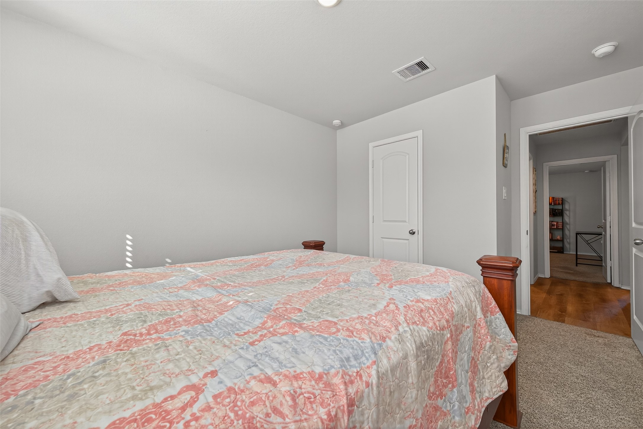 23706 Blodgett Peak Trail Spring, TX 77373 - Photo 19 of 31 a bedroom with a bed and wooden floor