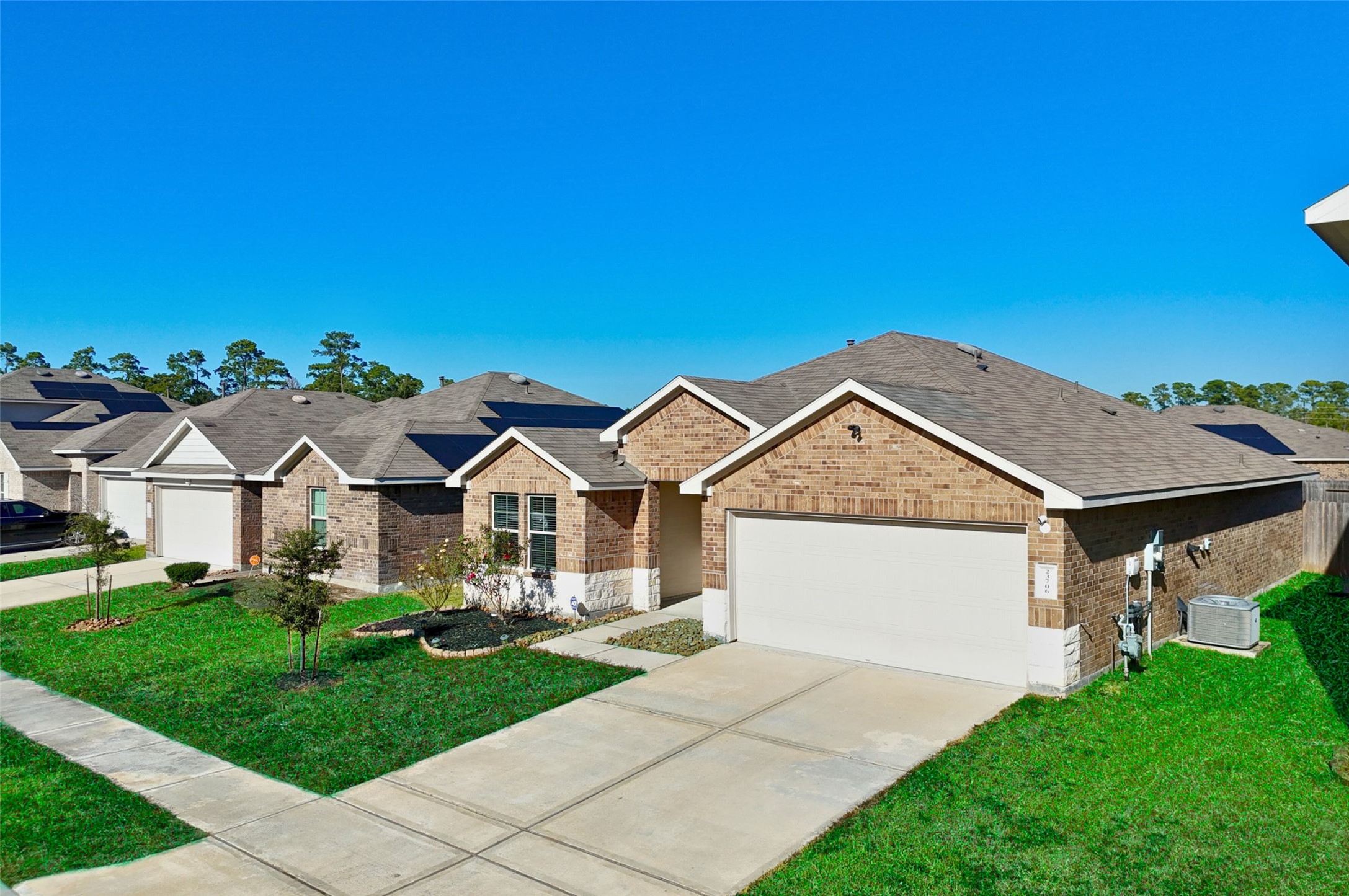23706 Blodgett Peak Trail Spring, TX 77373 - Photo 2 of 31 Well Maintained home with brick and stone elevation. 2 Car Garage. Photo enhanced for marketing purposes. Lawn appearance digitally improved.