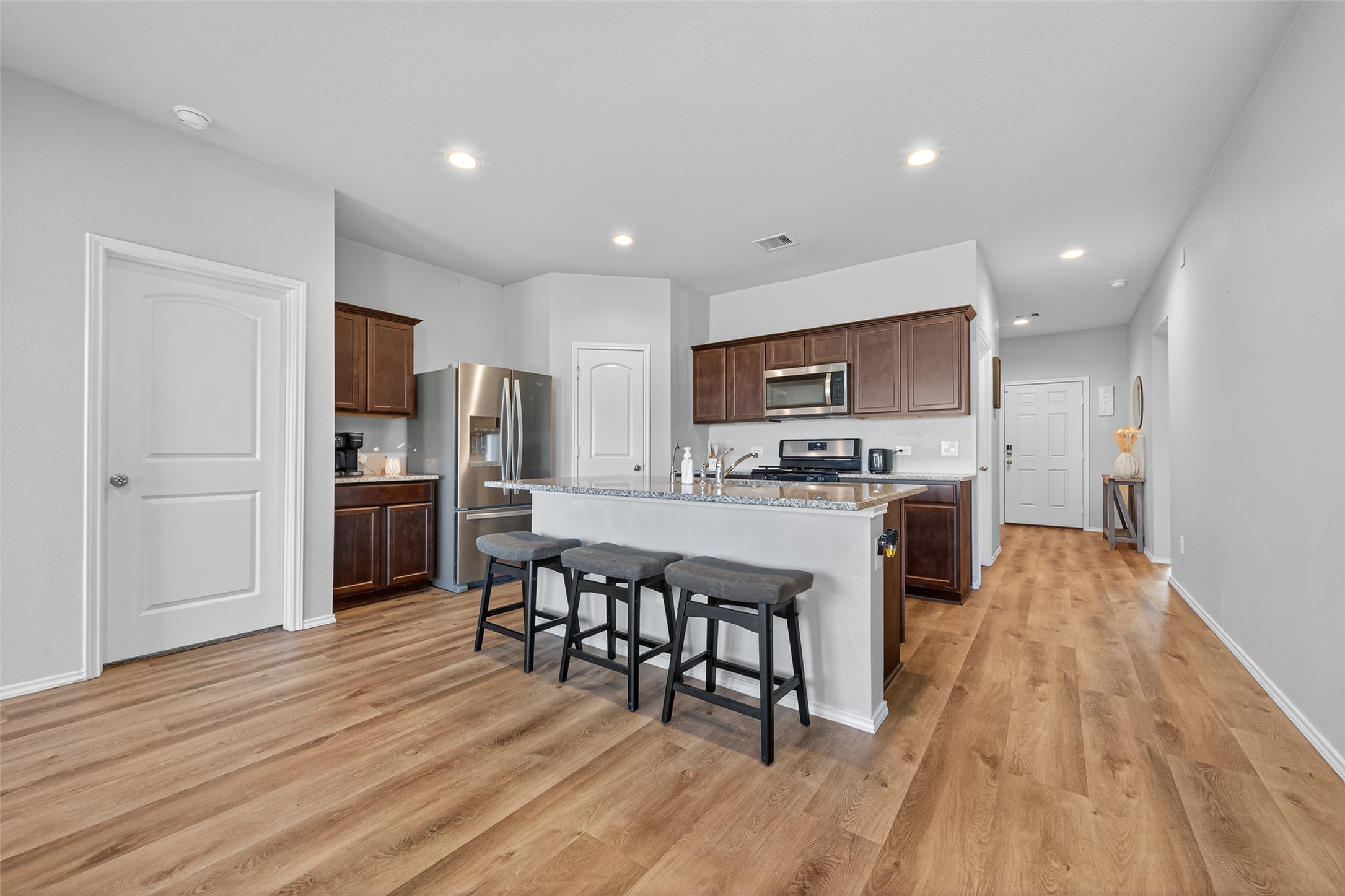 23706 Blodgett Peak Trail Spring, TX 77373 - Photo 4 of 31 a kitchen with stainless steel appliances a refrigerator and a stove top oven