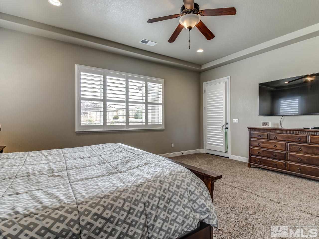 505 Split Rail Court Sparks, NV 89441 - Photo 12 of 25 a bedroom with a bed and a flat screen tv