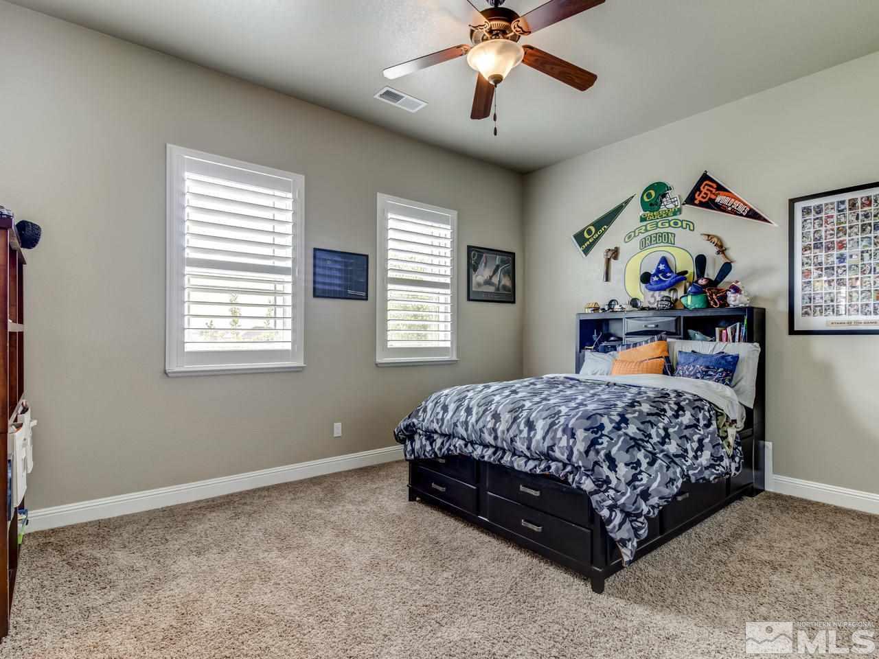 505 Split Rail Court Sparks, NV 89441 - Photo 15 of 25 a bedroom with a bed and a chandelier