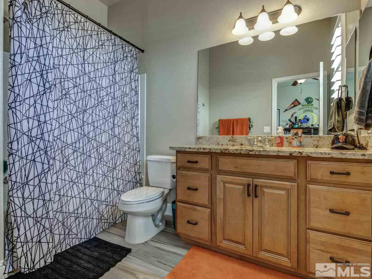 505 Split Rail Court Sparks, NV 89441 - Photo 16 of 25 a bathroom with a sink a toilet and a mirror
