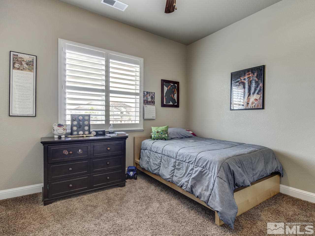 505 Split Rail Court Sparks, NV 89441 - Photo 17 of 25 a bedroom with a bed and a window