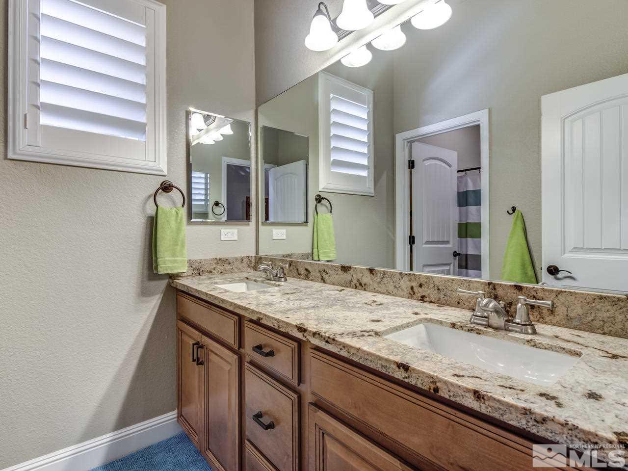 505 Split Rail Court Sparks, NV 89441 - Photo 18 of 25 a bathroom with a granite countertop sink and a mirror