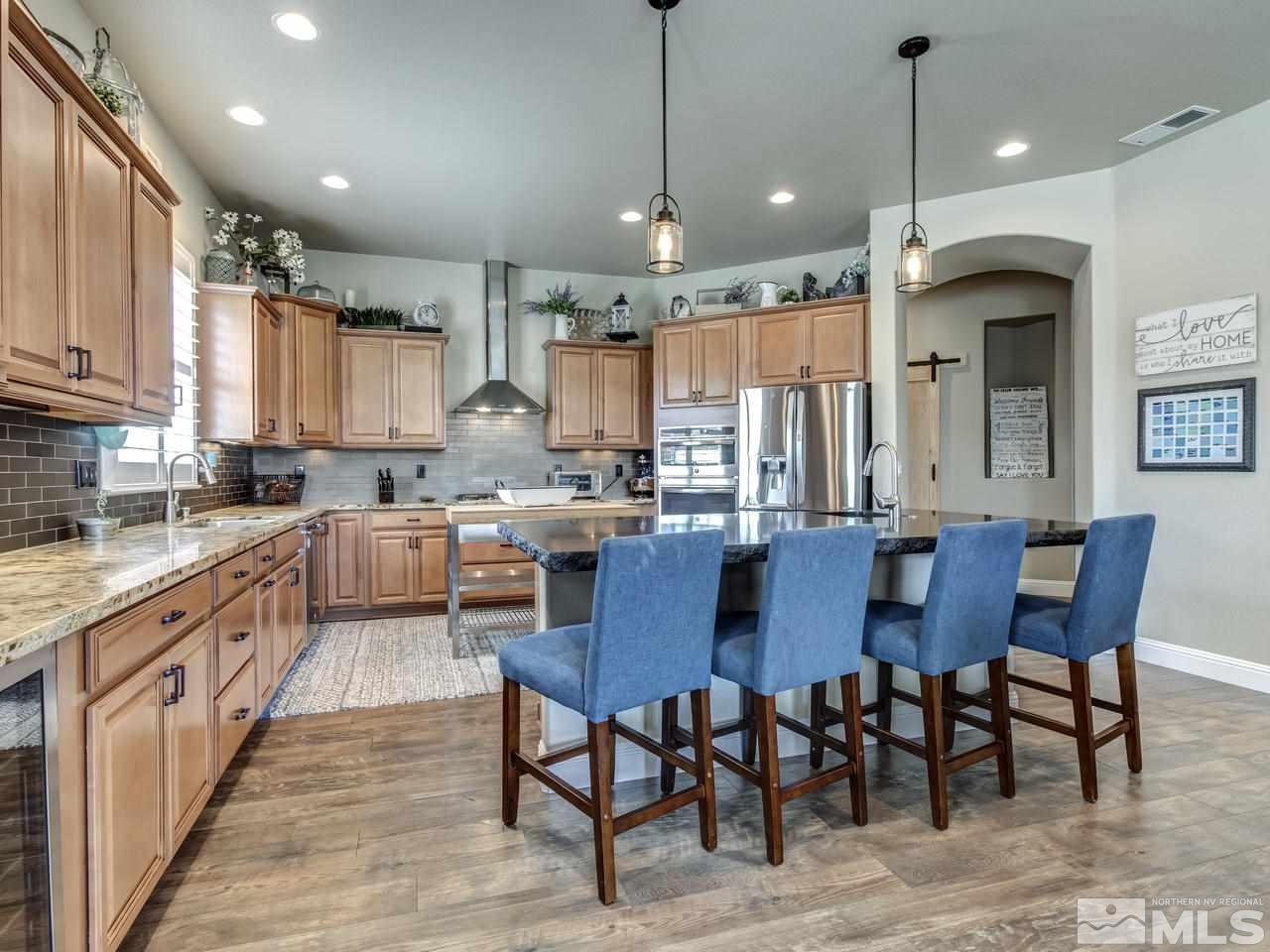 505 Split Rail Court Sparks, NV 89441 - Photo 7 of 25 a kitchen with stainless steel appliances granite countertop a table chairs sink refrigerator and cabinets