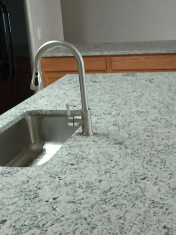 a bathroom with a toilet sink vanity and shower