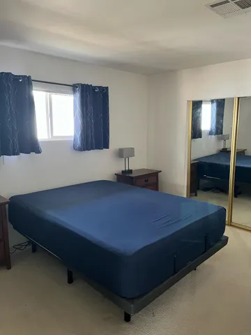 a bedroom with a bed and window