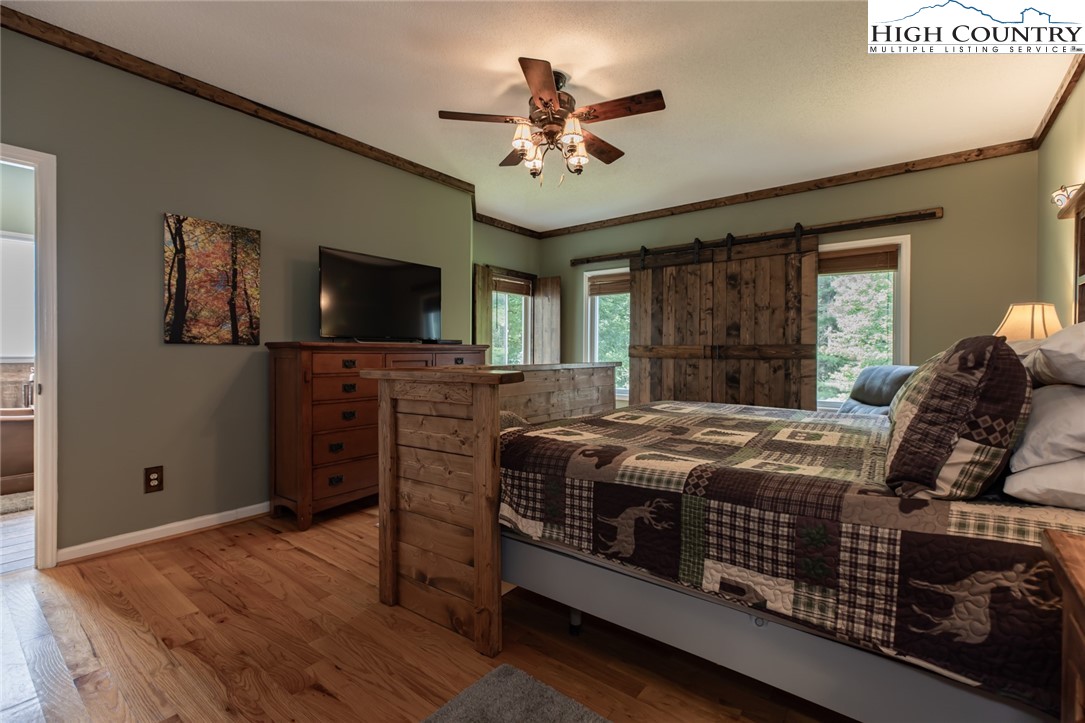 1328 Don Bare Road Jefferson, NC 28640 - Photo 23 of 49 a bedroom with a bed and a flat screen tv