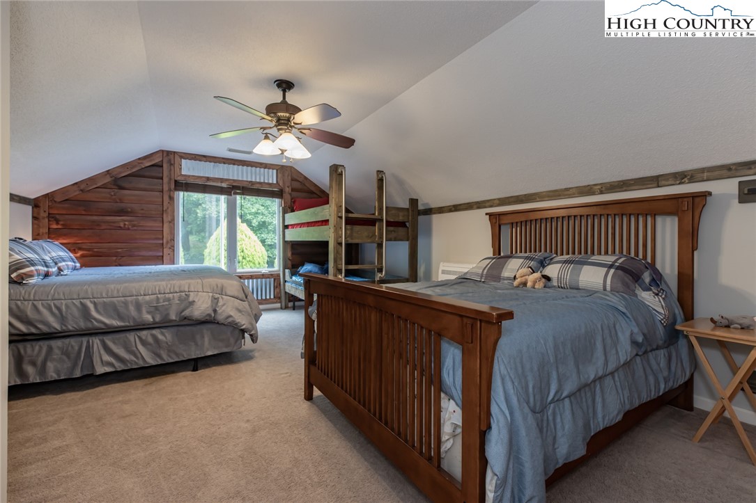 1328 Don Bare Road Jefferson, NC 28640 - Photo 31 of 49 a bedroom with a bed and a chandelier