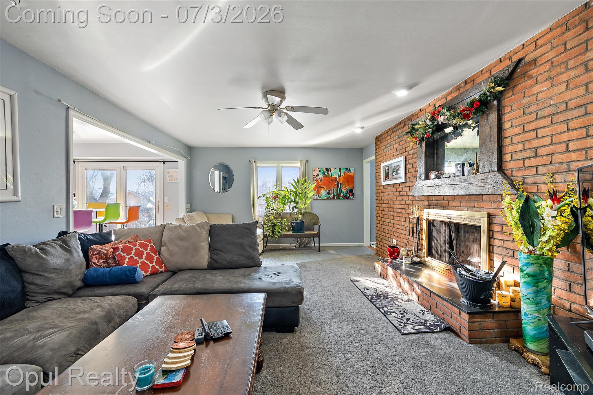 8855 Gross Road Dexter, MI 48130 - Photo 32 of 53 Living room featuring a brick accent wall with a built-in fireplace, ceiling fan, recessed lighting, and a doorway with French doors
