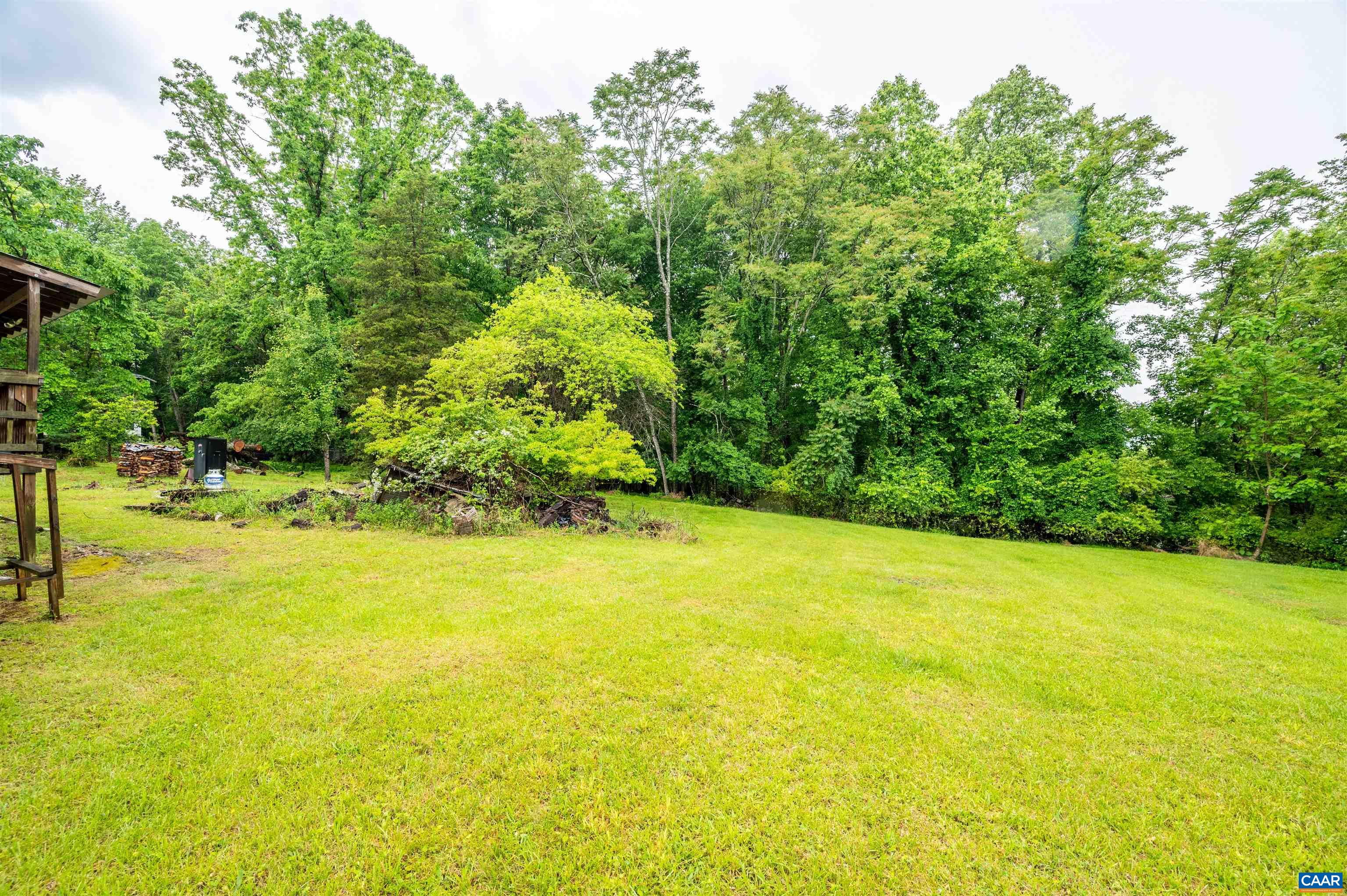 1126 Dry Bridge Road Charlottesville, VA 22903 - Photo 3 of 5 a view of a large yard with an outdoor space and seating area
