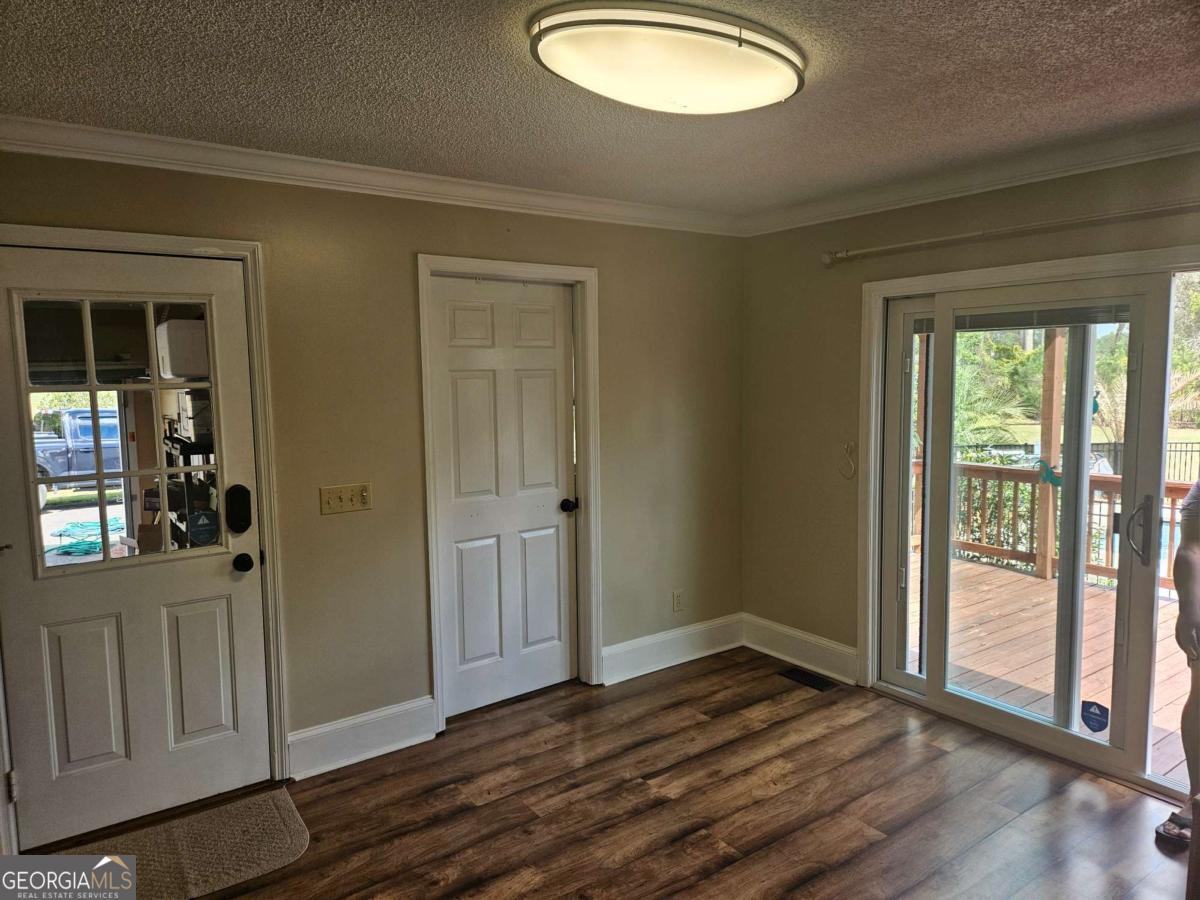 2001 Rutland Road, Unit 1 Tifton, GA 31793 - Photo 31 of 51 a view of an empty room with wooden floor and a window