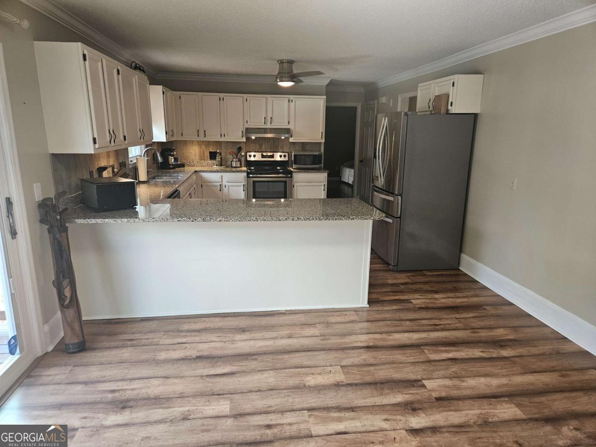 2001 Rutland Road, Unit 1 Tifton, GA 31793 - Photo 34 of 51 a kitchen with stainless steel appliances granite countertop a refrigerator sink and stove
