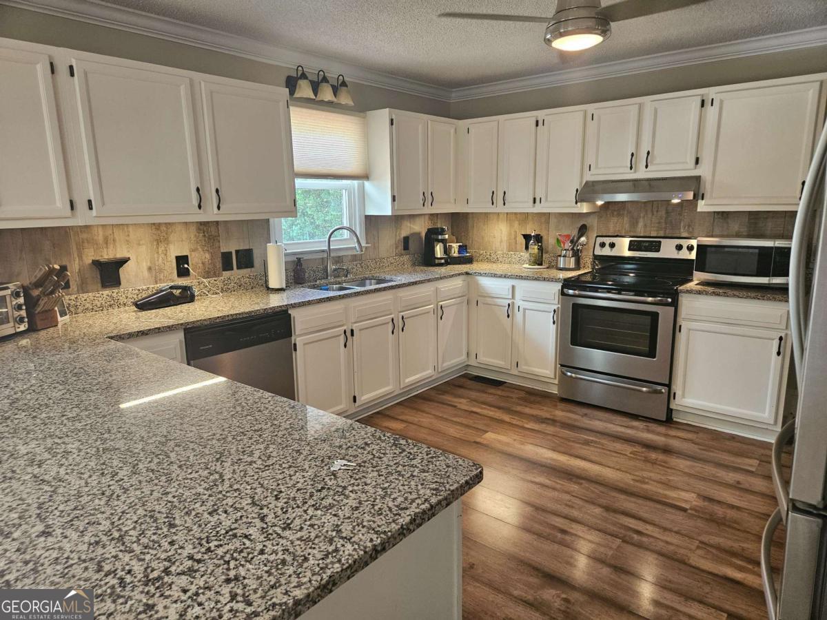 2001 Rutland Road, Unit 1 Tifton, GA 31793 - Photo 35 of 51 a kitchen with a sink window and cabinets